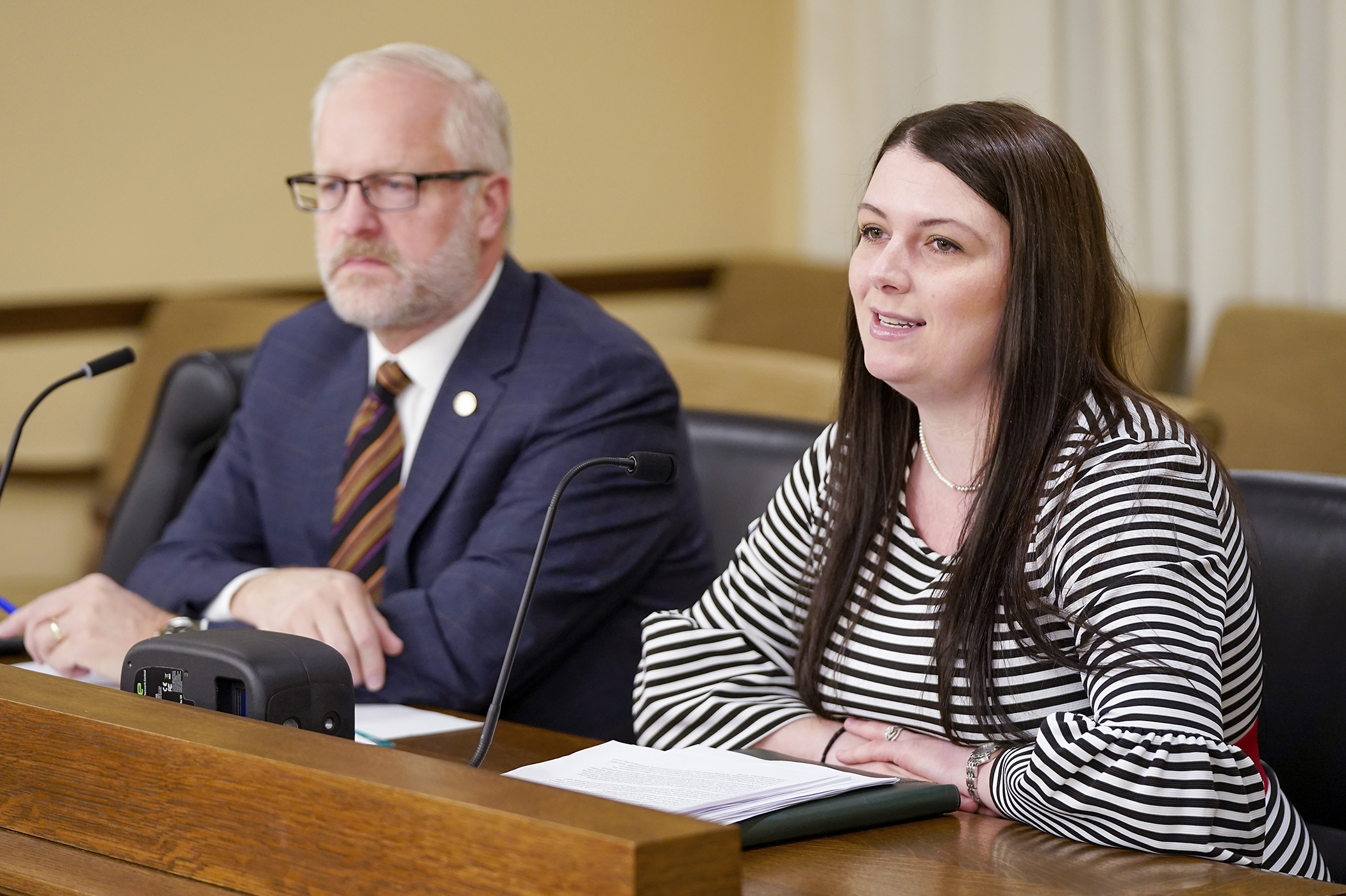 RaeAnna Lee, legislative and coalitions director for Minnesota Americans for Prosperity, testifies in support of HF3 before the House State Government Finance and Policy Committee Feb. 11. Rep. Jim Nash, left, sponsors the bill. (Photo by Michele Jokinen)